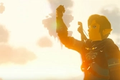Link raises a clenched fist skyward. 