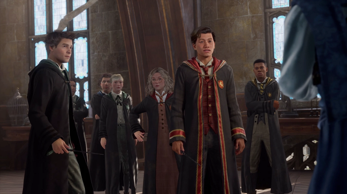A Gryffindor student alongside other Hogwarts students in a group, in Hogwarts Legacy.