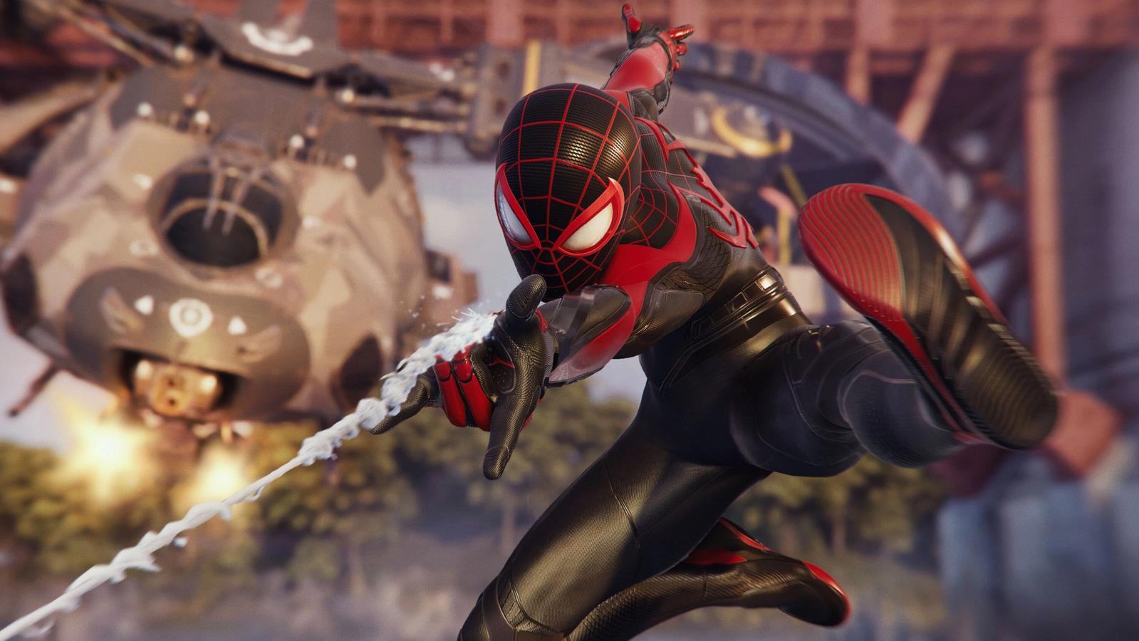 spider-man 2 miles morales swinging web at screen with helicopter in background