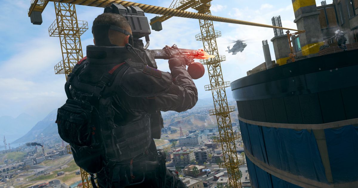 A solider ziplining while firing an assault rifle across to another high-rise building.