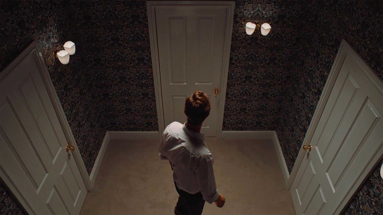 Josh facing three doors in a puzzle in The Isle Tide Hotel.