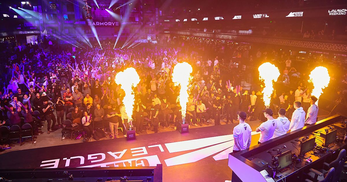 Screenshot of CDL main stage with players standing near monitors and flames firing into the air in front of spectators 
