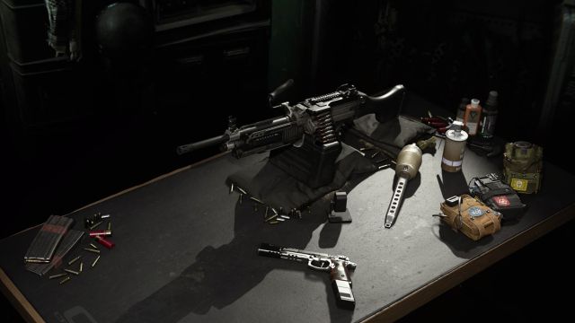 Image showing Modern Warfare LMG on table surrounded by equipment