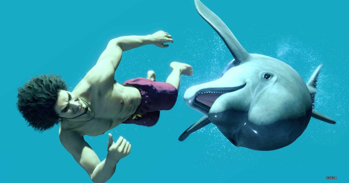 Like a Dragon Infinite Wealth protagonist Ichiban Kasuga swimming next to a dolphin