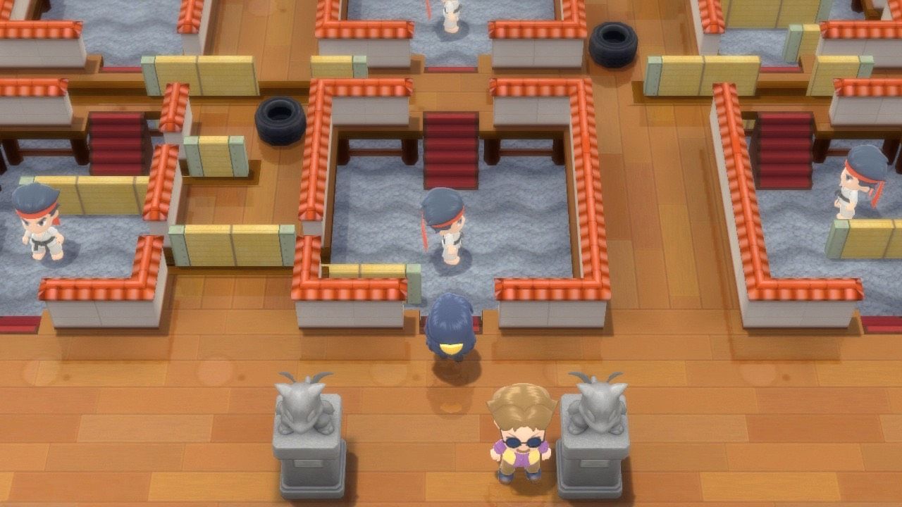 A Pokémon Trainer inside of Pastoria City Gym, facing Black Belt Trainers and a puzzle in Pokémon Brilliant Diamond and Shining Pearl.