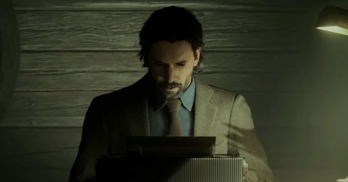 Alan Wake 2 - dark haired man in a grey suit sat at a typewriter, looking down