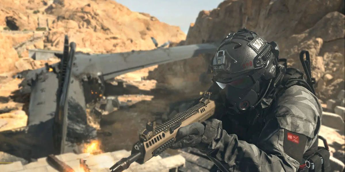 Screenshot of Warzone 2 player firing battle rifle next to burning plane wreckage in the desert
