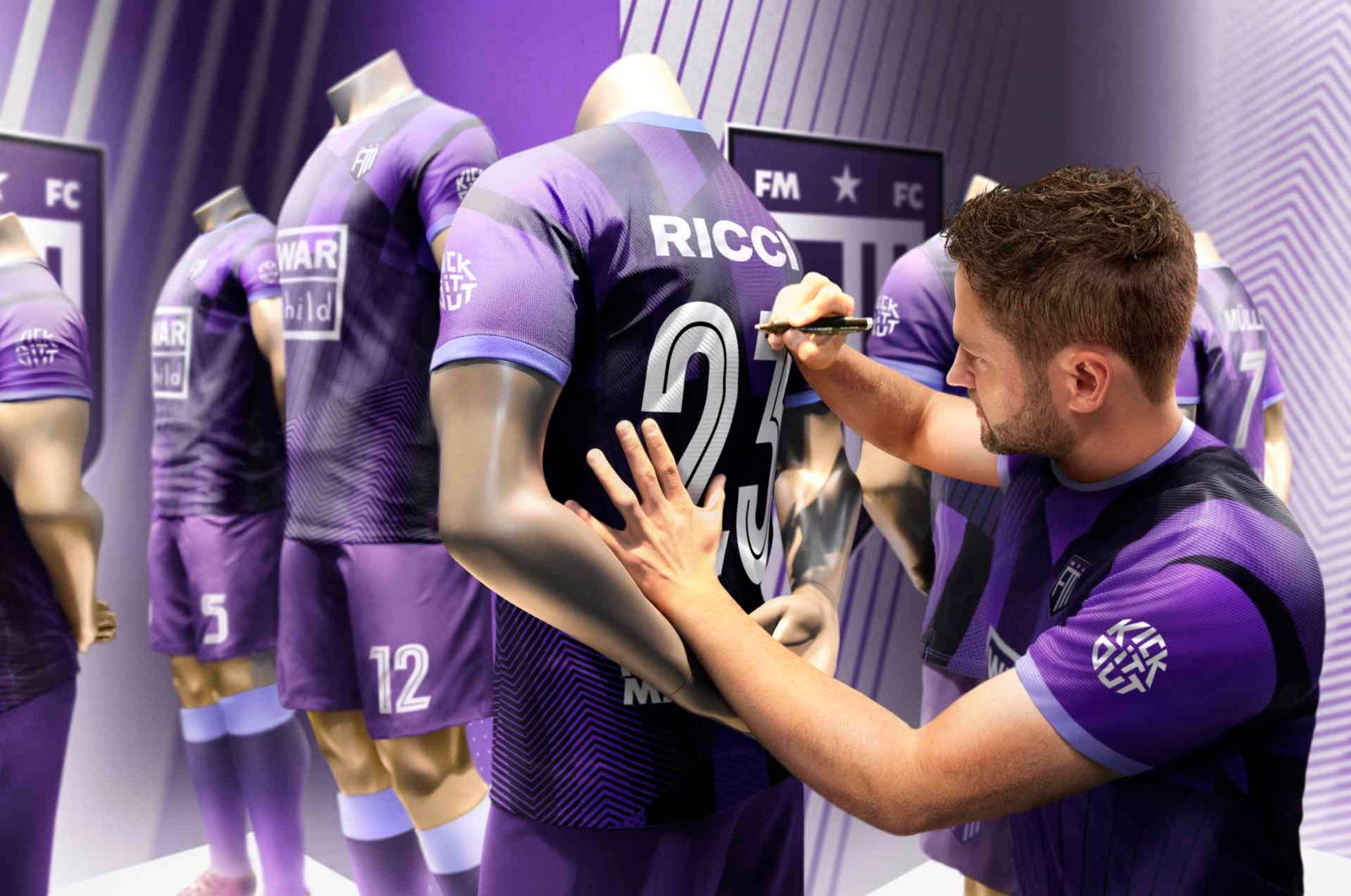 A Football Manager 23 player signing the back of a football shirt.