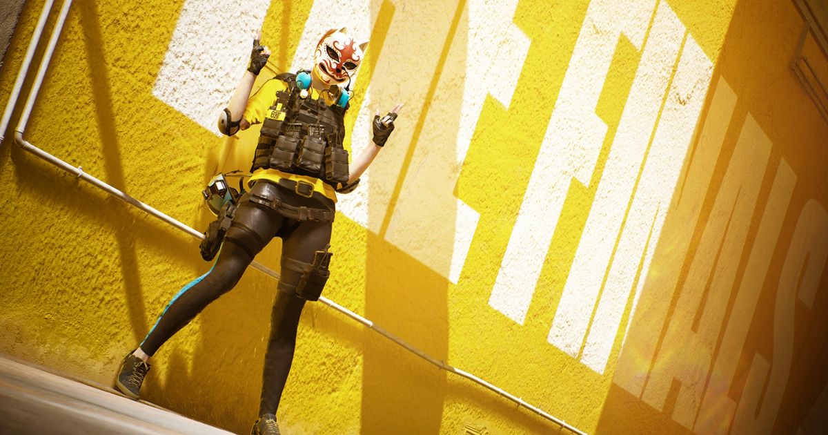 The Finals: person in a wolf mask gesturing with their hands in front of a yellow wall