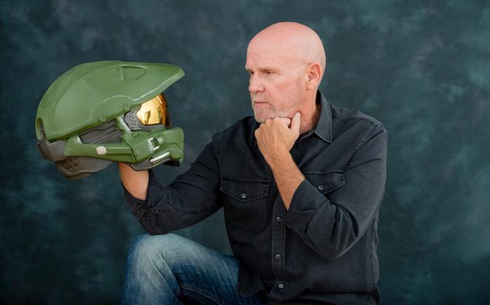 Steve Downes is holding a Master Chief helmet.