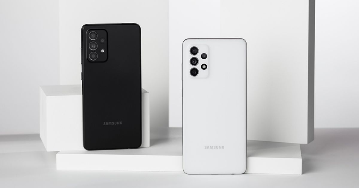 Two Samsung phones in a white room, the one on the right black, the one on the left being white.