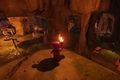 Character exploring a cave with a torch in LEGO Fortnite.