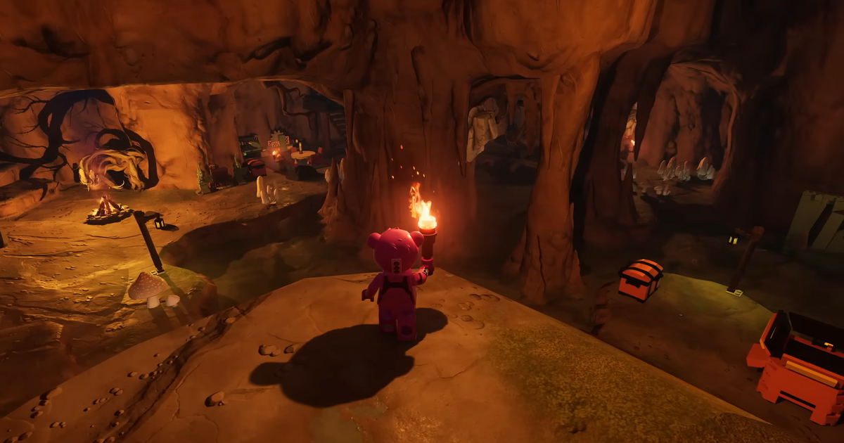 Character exploring a cave with a torch in LEGO Fortnite.