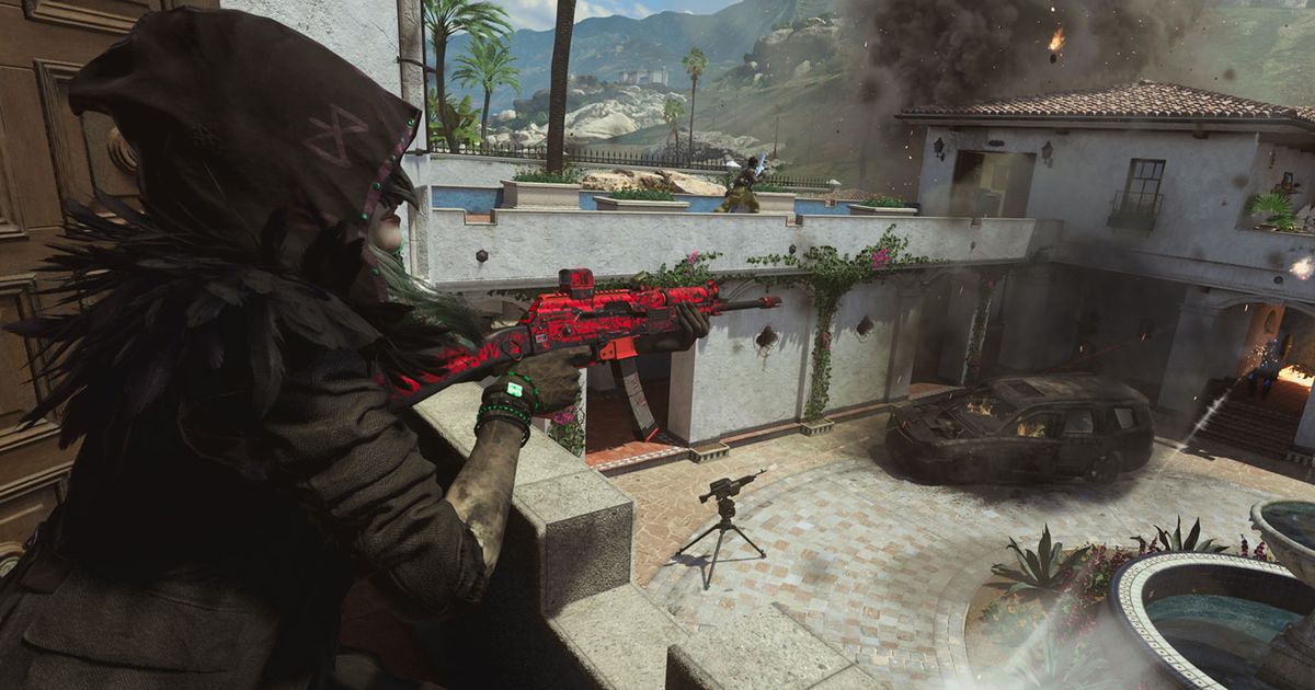 Modern Warfare 2 player holding gun while overlooking sentry gun in front of burning vehicle