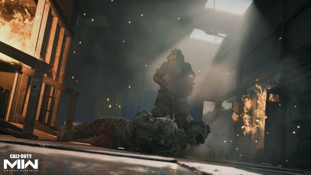 Image showing two Modern Warfare 2 players in dark room