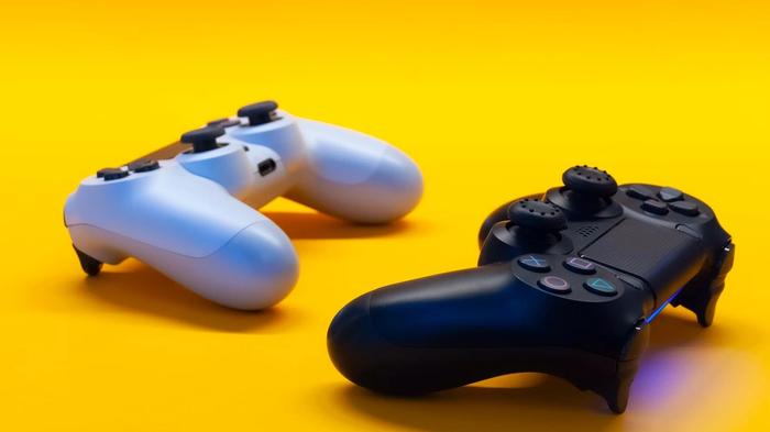 Two PlayStation controllers against a white background