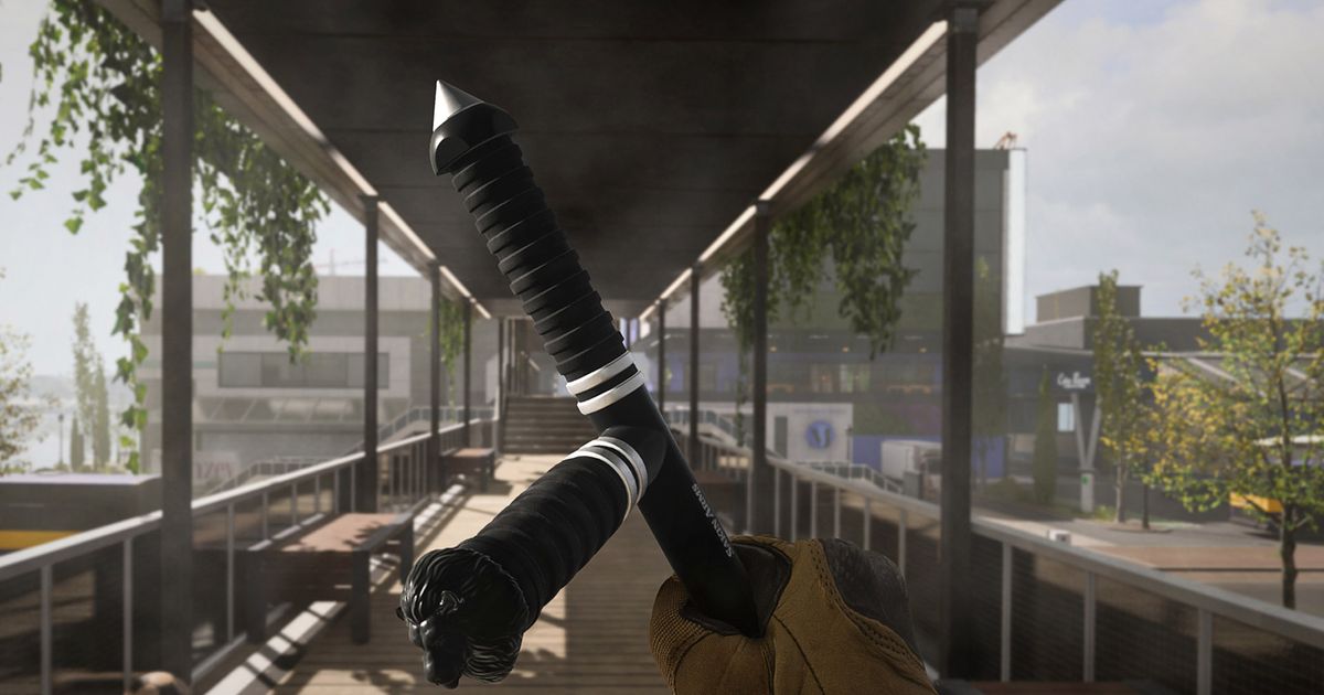 Screenshot showing Tonfa melee weapon held by Call of Duty player with a wooden catwalk in the background