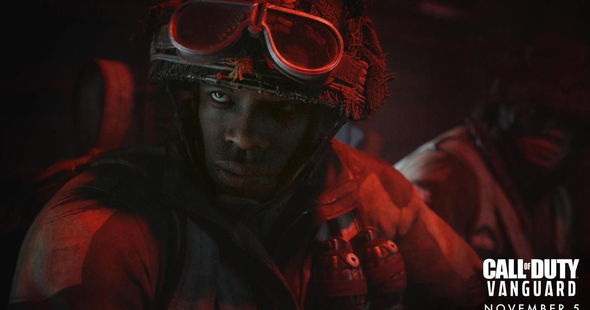 A Call of Duty: Vanguard operator looks past the camera in the dark.