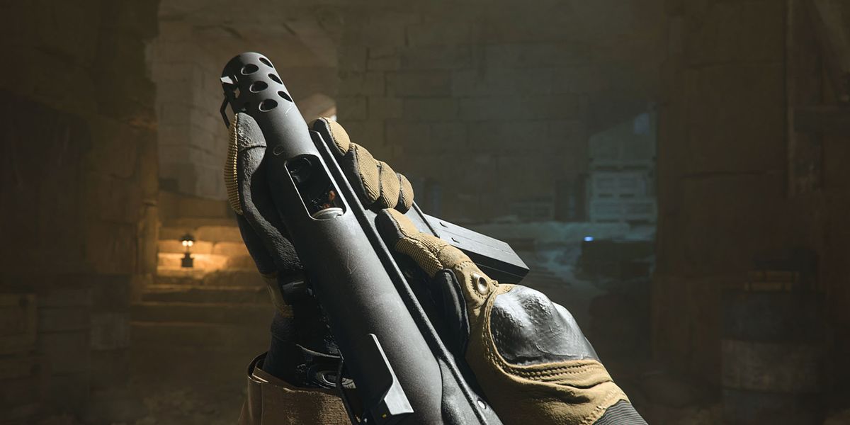 Screenshot of Modern Warfare 2 player holding an FTAC Siege pistol with both hands in dimly lit cave