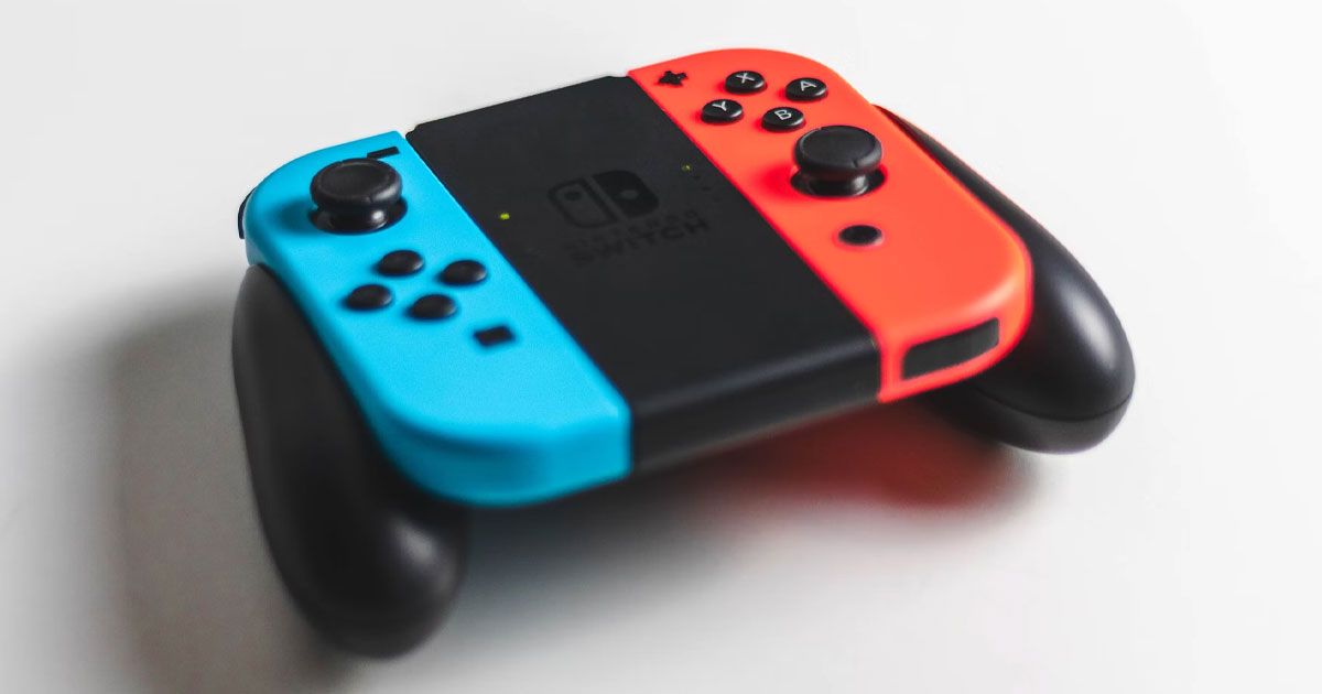 A blue and a red Joy-Con controllers attached to a black controller mount.
