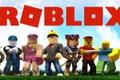 Roblox logo in red in front of a blue sky and above a group of Roblox characters.