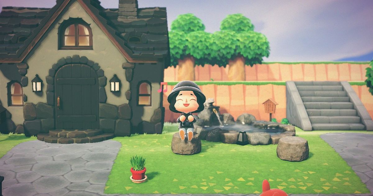A player sat outside of their home in Animal Crossing: New Horizons.