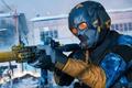 Modern Warfare 3 / Warzone - soldier in blue and orange with a full-face mask holding a suppressed sub-machine gun.