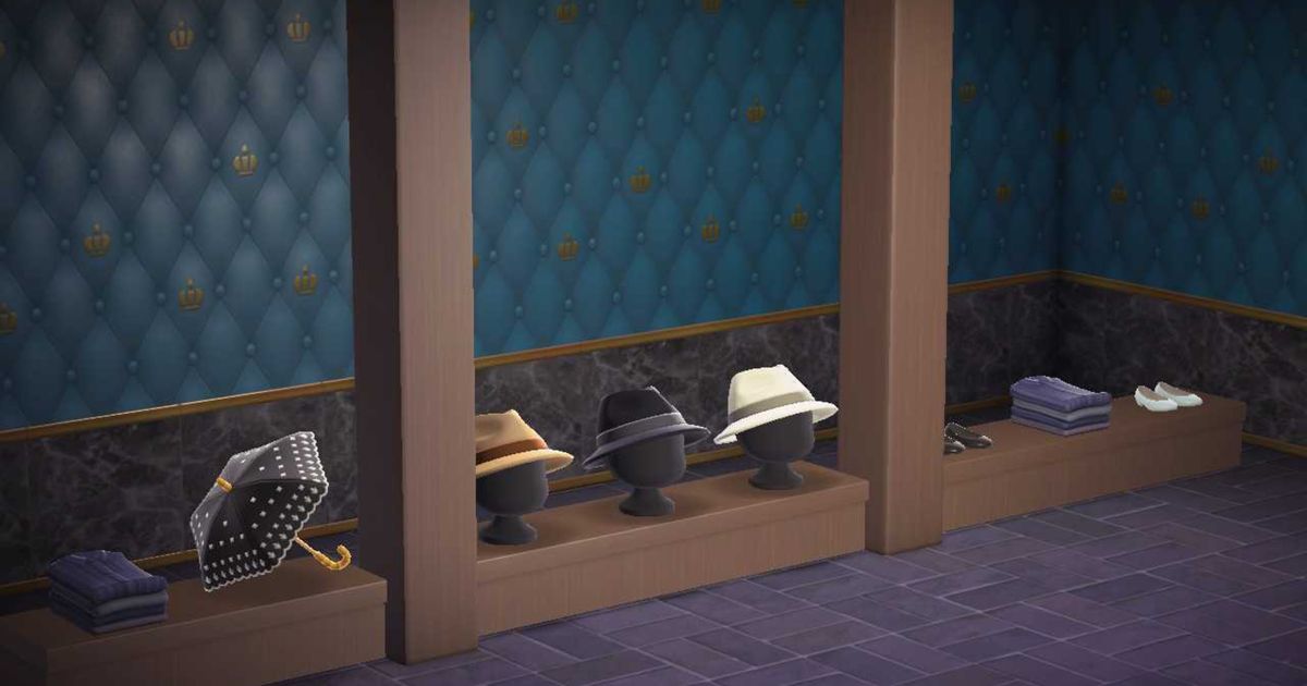 Animal Crossing New Horizons Happy Home Paradise. The image shows two dark wood pillars and eight dark wood low wooden island counters. There are items of clothing on top of the counters. 