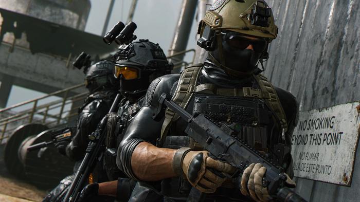 Image showing Modern Warfare 2 players standing out side door holding guns