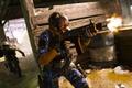 Modern Warfare 3 player firing assault rifle inside bunker with sprinting teammate in background