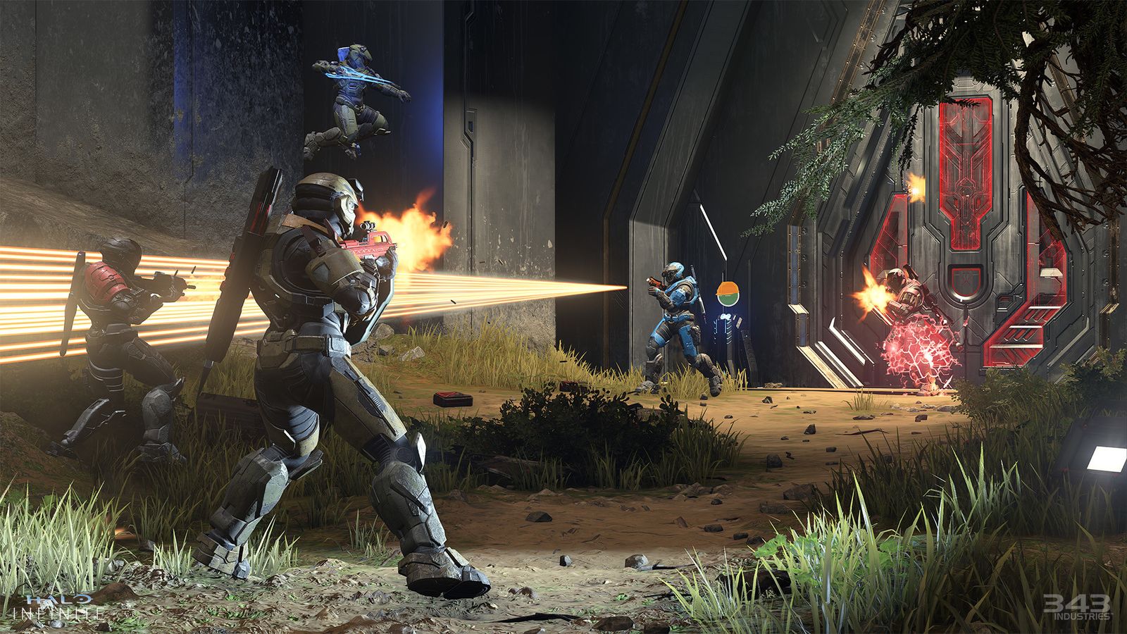 Two Spartans are shooting at two other enemies in Halo Infinite.