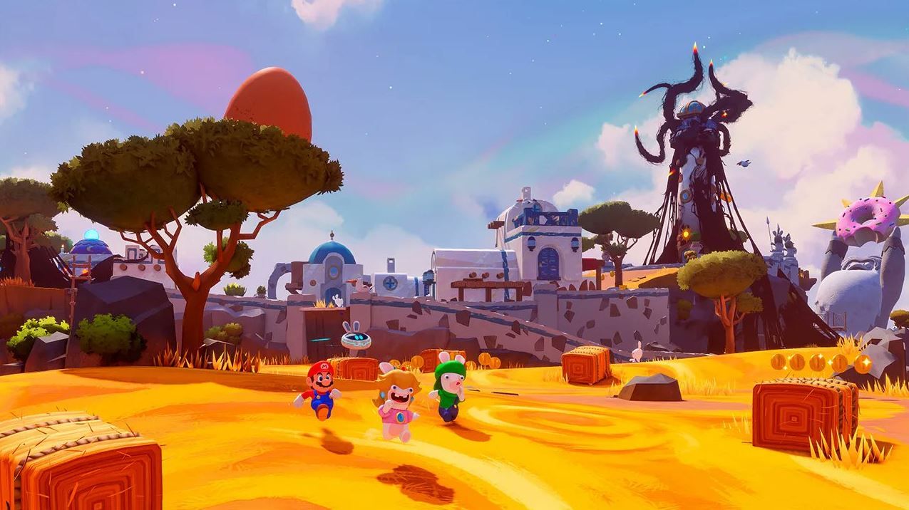 The image shows Mario, Rabbid Luigi, and Rabbid Peach walking along a field.