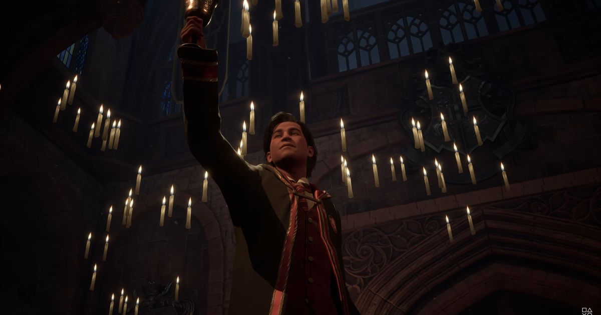 The player character holding up a cup in the Great Hall in Hogwarts Legacy
