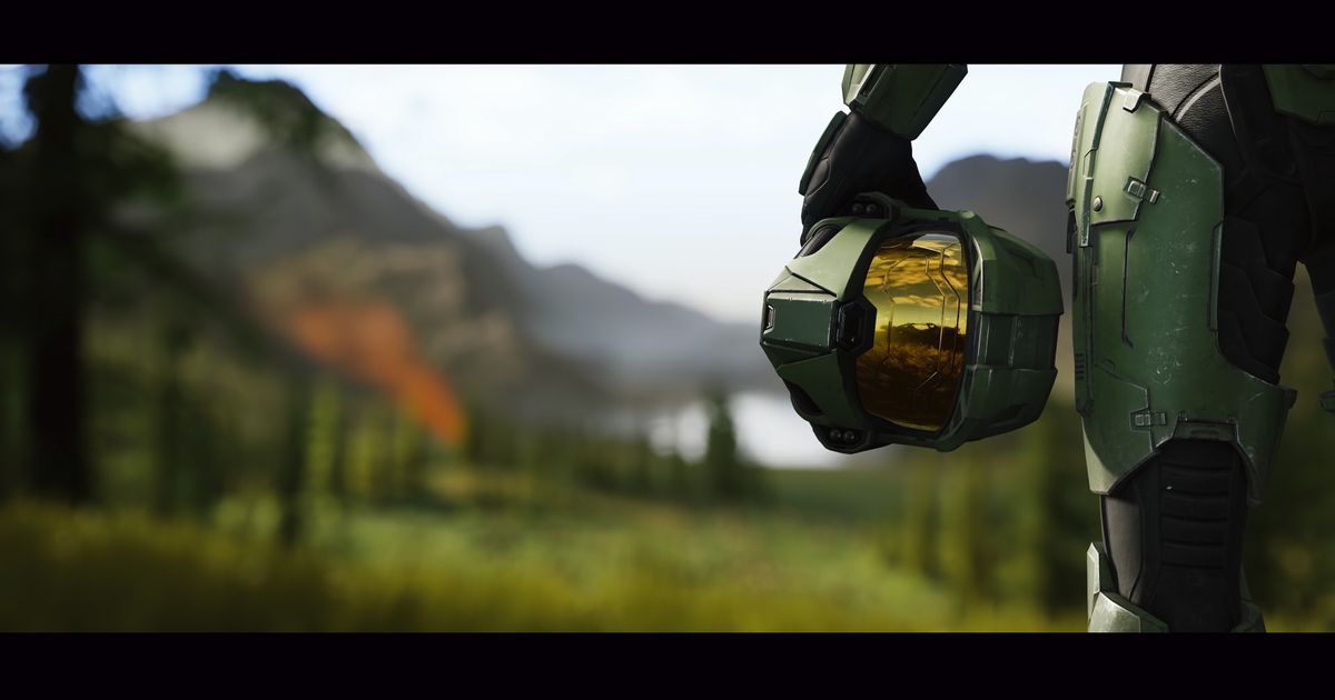 The image of Master Chief holding his helmet by his side in a Halo Infinite promotional shot.