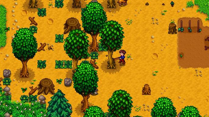 Stardew Valley, The player is chopping a tree down. The player is stood on their farm in red dungarees and chopping down a green tree on their left with an axe.Stardew Valley, The player is chopping a tree down. The player is stood on their farm in red dungarees and chopping down a green tree on their left with an axe.
