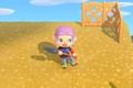 Animal Crossing New Horizons. The Player is holding a Shovel. They are standing on top of a cliff and there is a bit of lattice fencing behind them.