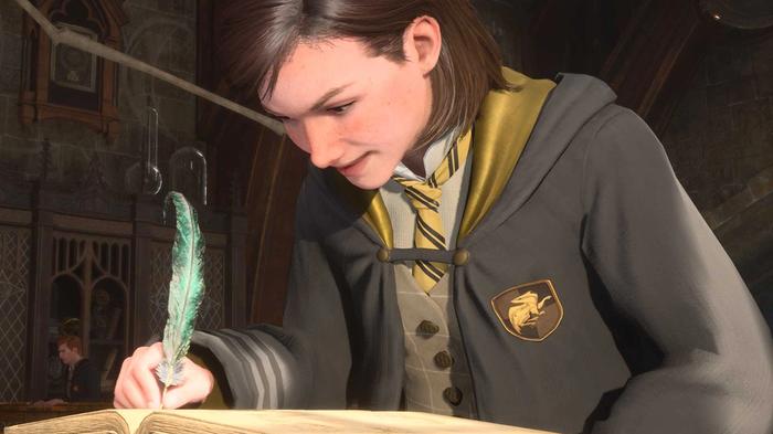 A student writing in a notebook in Hogwarts Legacy. 