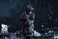 Call of Duty character stood in black tactical gear in the rain, holding a rifle.