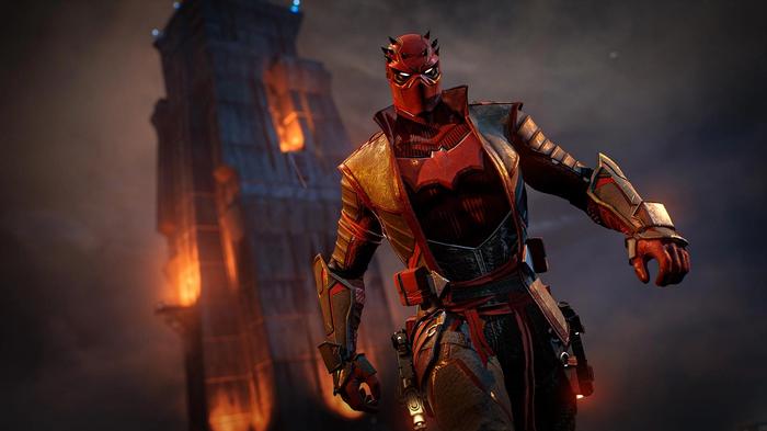 Red Hood in front of a burning building in Gotham Knights