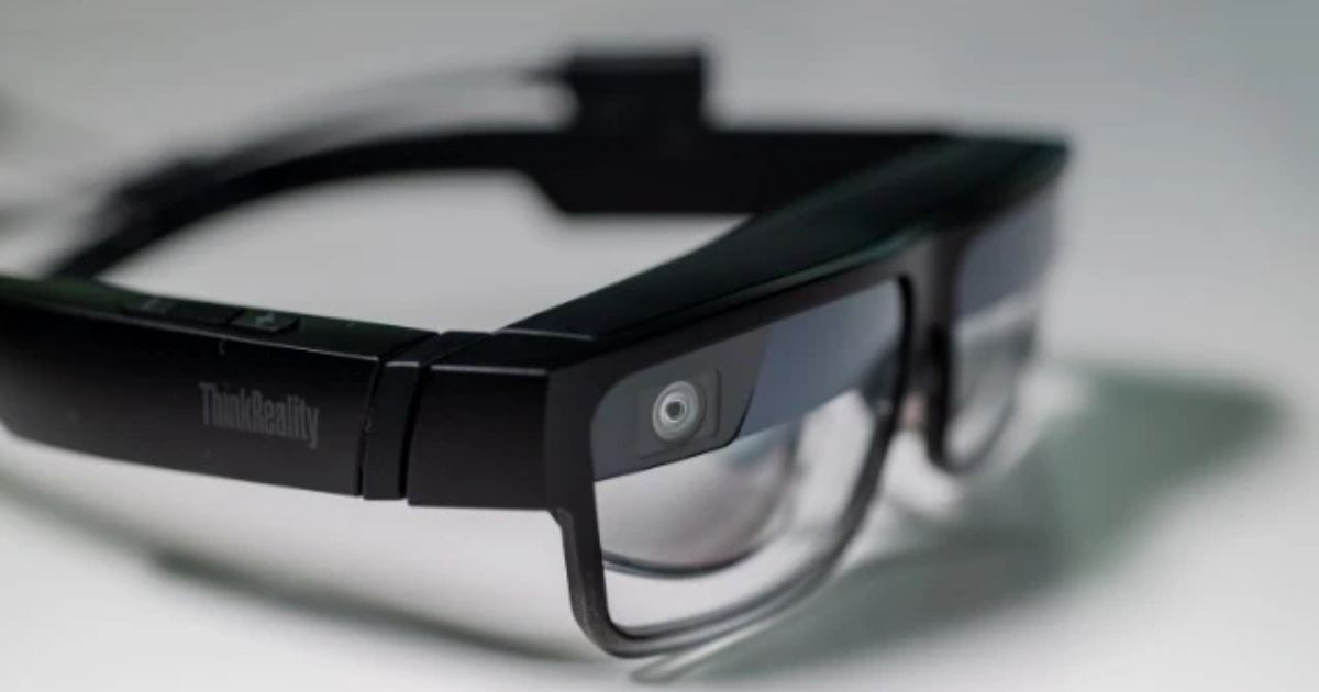 A set of black smart glasses with clear lenses out of focus.