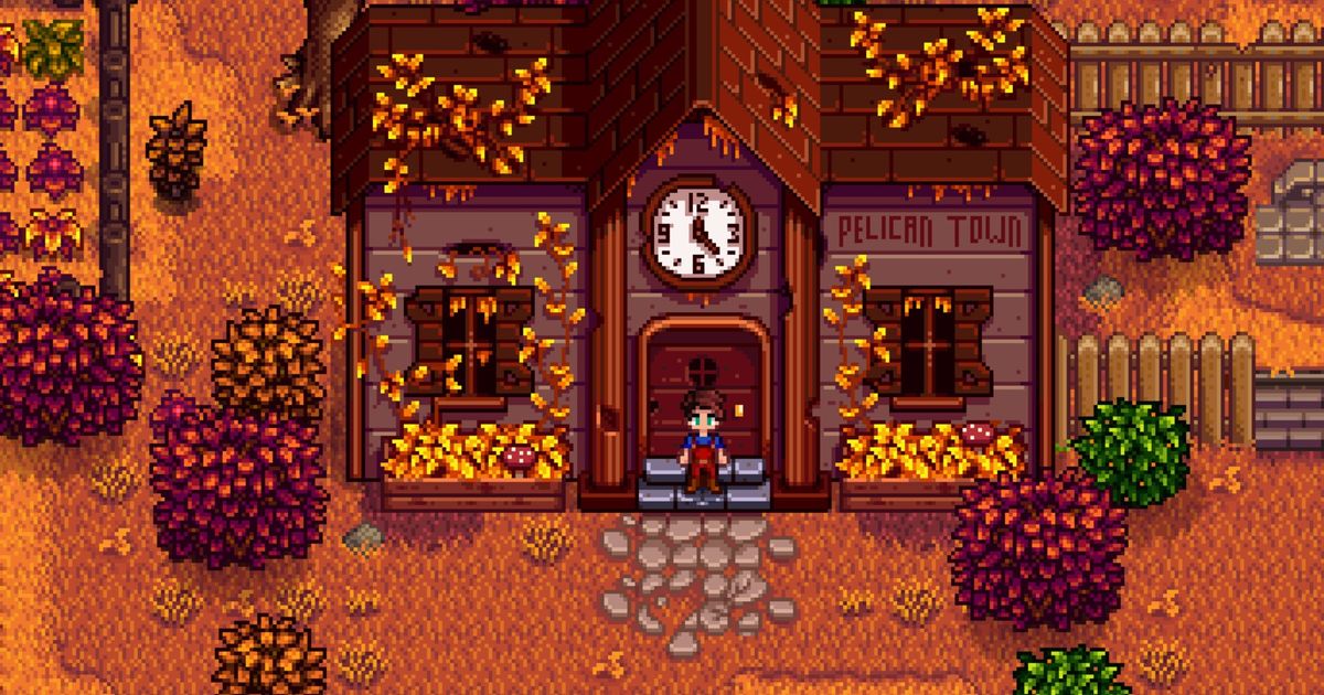 Stardew Valley. The player is standing outside the old community center in Fall. The building behind the player is covered in overgrown vines and the words "pelican town" are written on the right side of it.