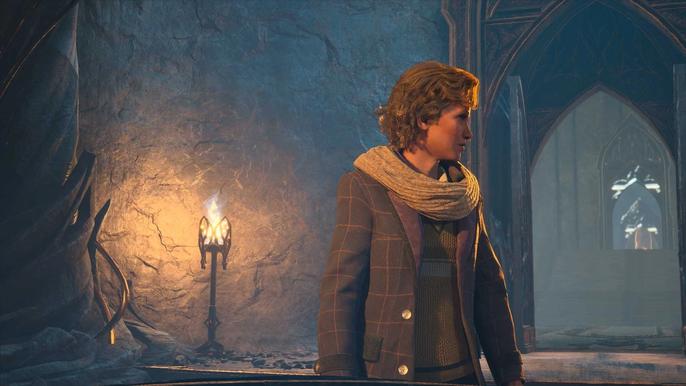 A player character looking back toward a window in Hogwarts Legacy, with a flaming torch just behind them.