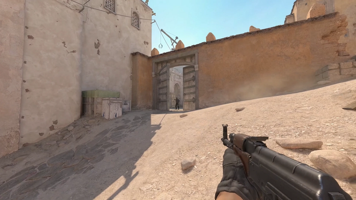 A players aims his gun at at enemy standing in the doors to B site on Dust 2