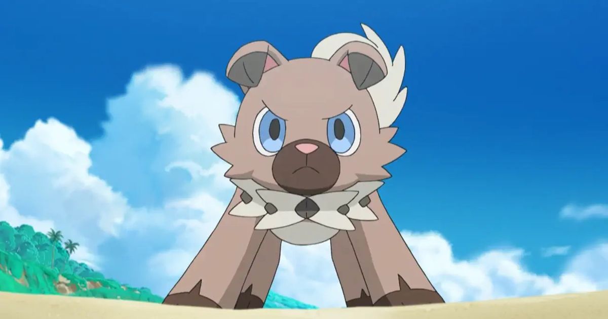 Pokemon Rockruff standing with blue sky and foliage in background