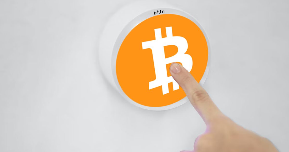 Finger pressing a Bitcoin button