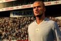 Screenshot of EA Sports FC Icon David Beckham in front of crowd with England banners