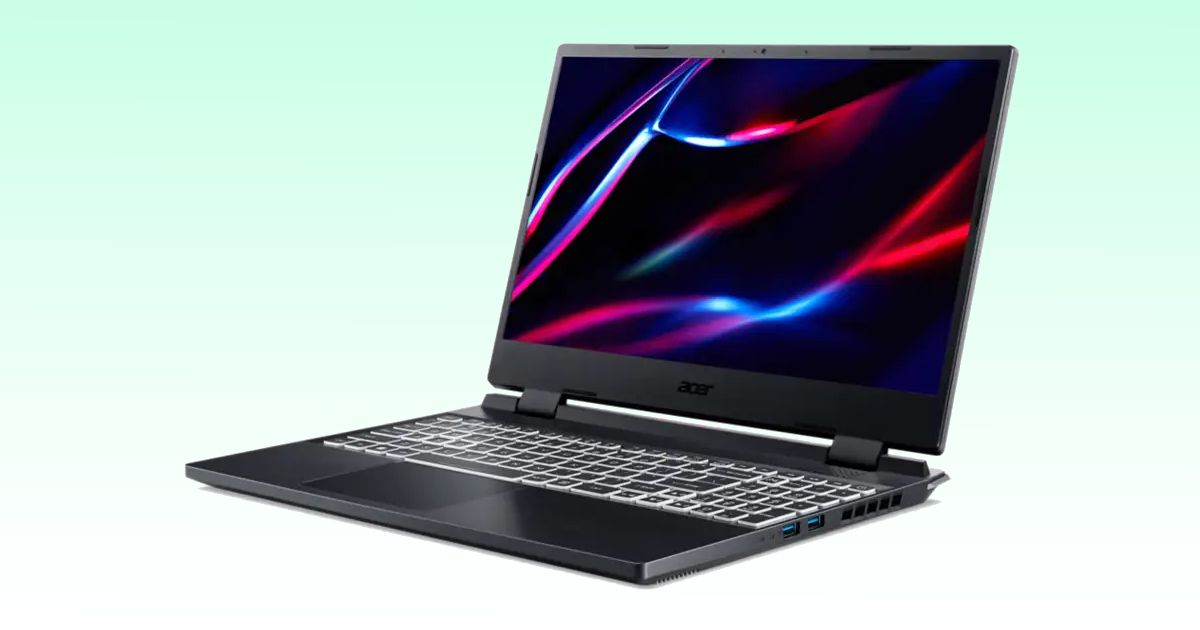 A black laptop with white backlit keys and a dark red and blue pattern on the screen.