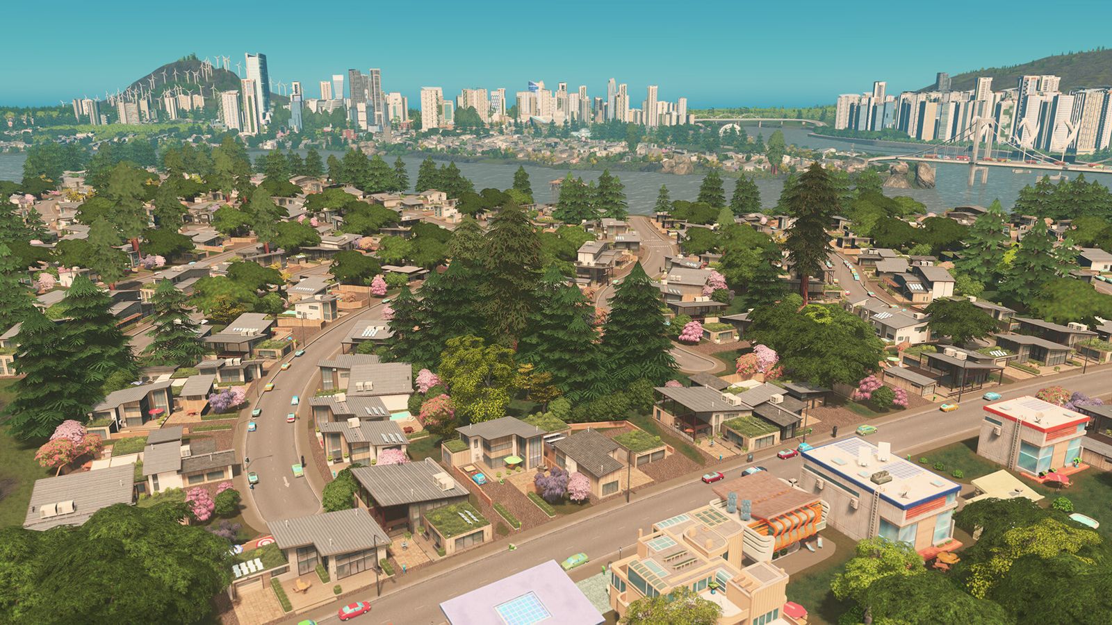 Cities: Skylines in-game image of a small town landscape with a high-rise city in the background across a river.