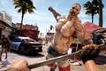 A first-person shot from Dead Island of someone holding a metal hammer attacking a zombie.