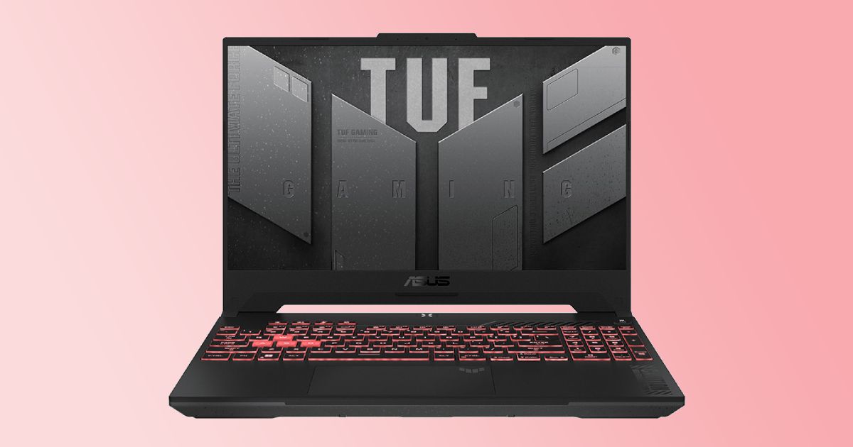 A black ASUS gaming laptop with TUF branding in gray on the screen and red backlit keys to match the gradient background.